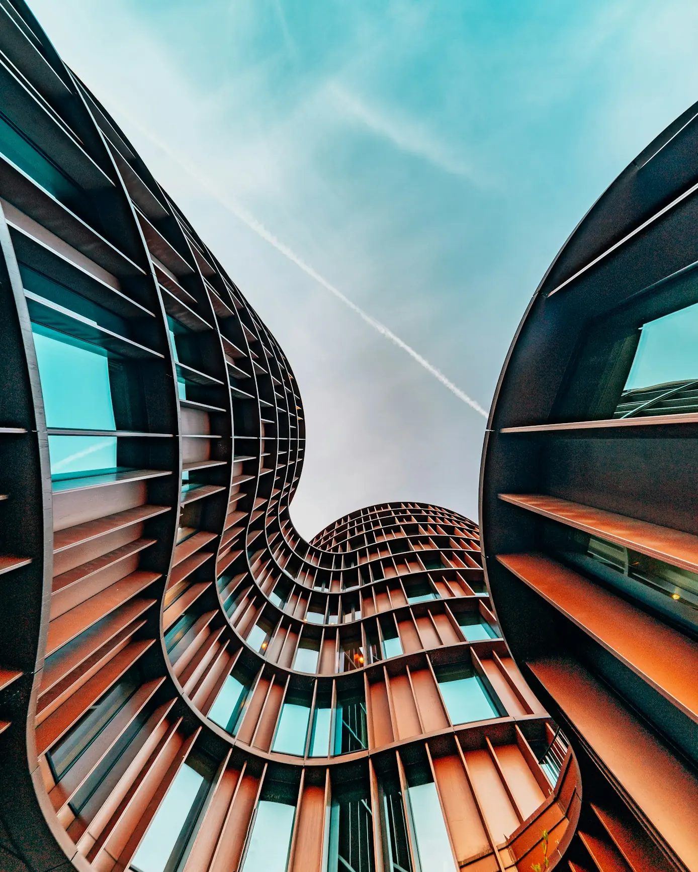 Curving modern architectural facade with terracotta fins